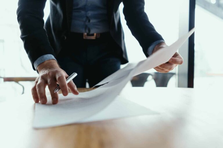 successful business man signing documents modern office 1